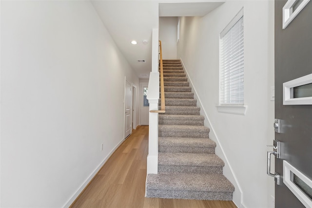 stairway featuring hardwood / wood-style flooring