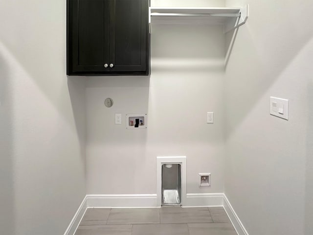 laundry area featuring washer hookup, electric dryer hookup, cabinets, and light tile patterned floors