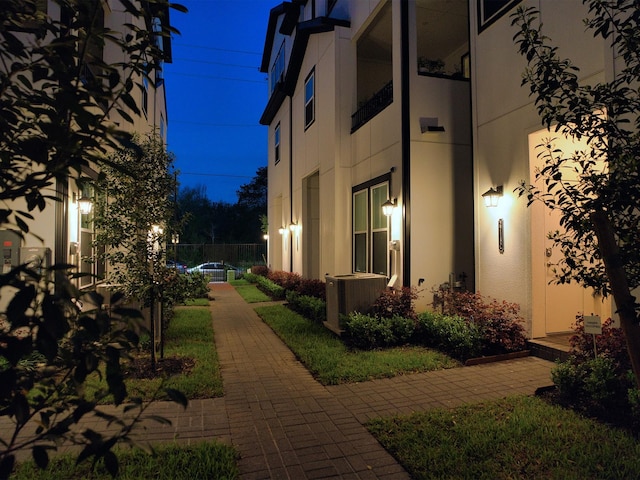 view of side of home featuring central AC