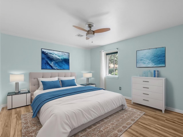 bedroom with ceiling fan and light hardwood / wood-style floors