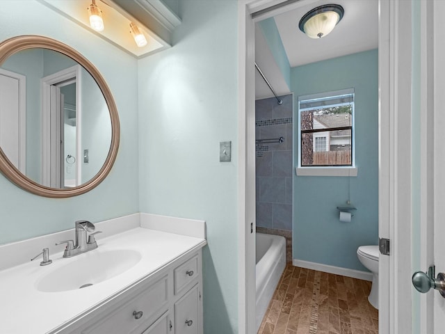 full bathroom featuring toilet, tiled shower / bath, and vanity