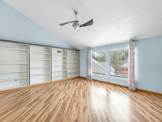 unfurnished living room featuring ceiling fan, light wood-type flooring, a textured ceiling, and lofted ceiling