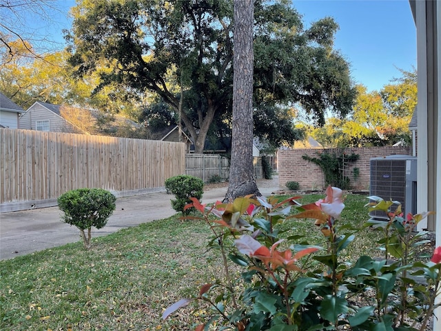 view of yard featuring a patio area and central air condition unit