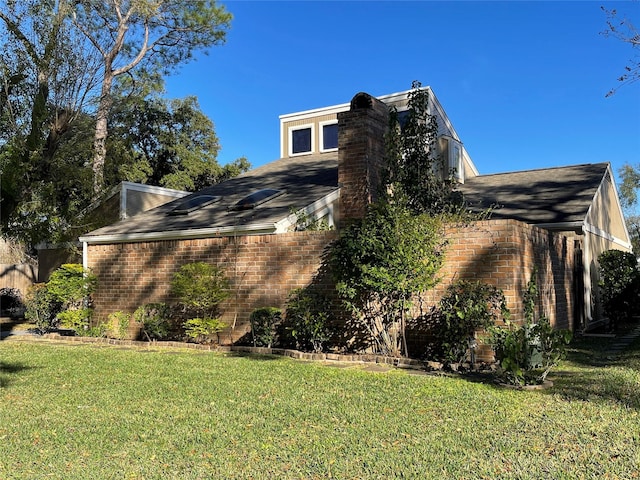 view of home's exterior with a yard