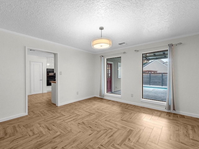 unfurnished room featuring light parquet flooring, a textured ceiling, and ornamental molding