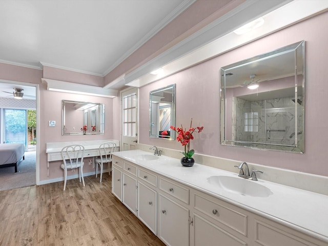 bathroom with vanity, crown molding, hardwood / wood-style floors, and an enclosed shower