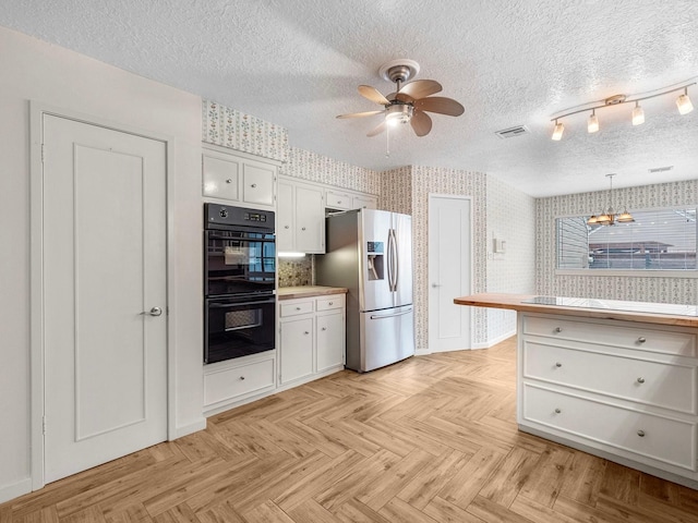 kitchen featuring white cabinetry, stainless steel refrigerator with ice dispenser, decorative light fixtures, double oven, and ceiling fan with notable chandelier