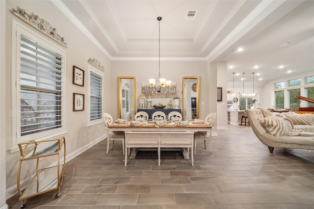 dining room featuring a tray ceiling and a chandelier