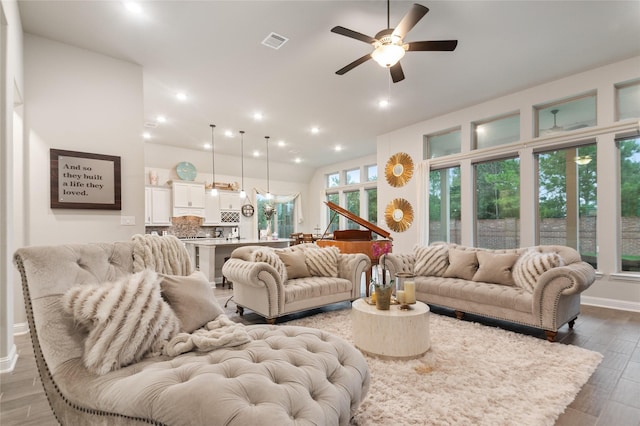 living room with hardwood / wood-style floors and ceiling fan