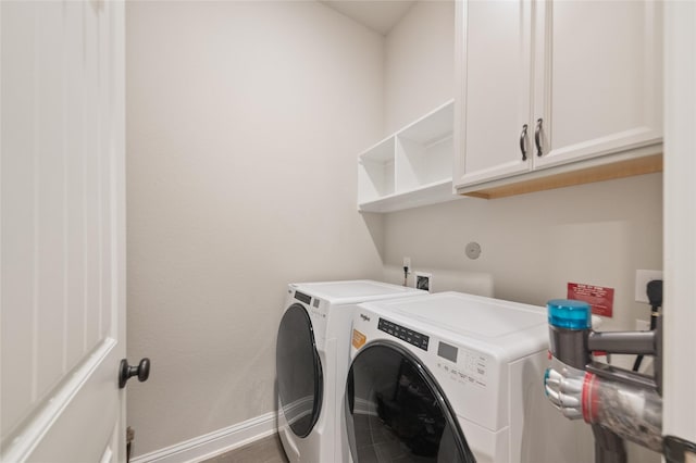 laundry area with cabinets and washing machine and clothes dryer