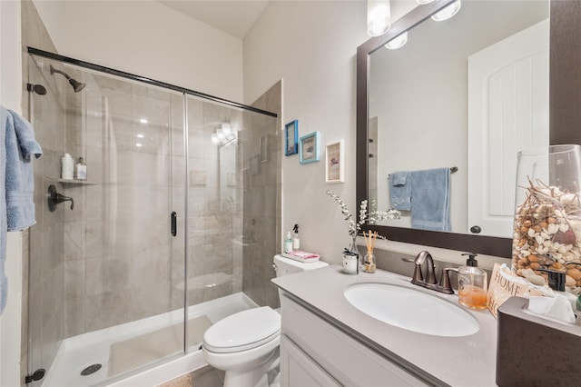 bathroom with vanity, an enclosed shower, and toilet