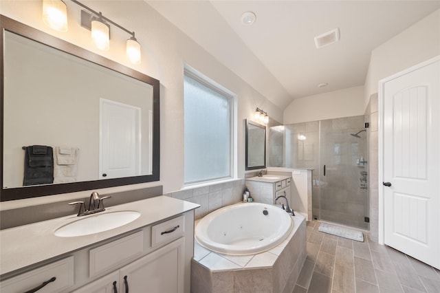 bathroom with separate shower and tub, vanity, and lofted ceiling