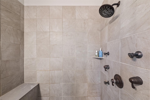 bathroom with a tile shower