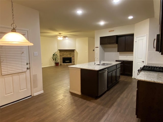12209 Renewal Way, Houston, TX 77047 - kitchen with ceiling fan, appliances with stainless steel finishes, a kitchen island with sink, a fireplace, and decorative light fixtures