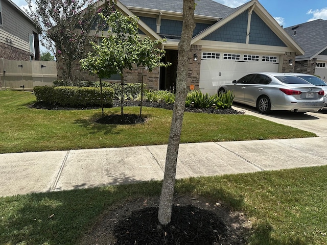 12209 Renewal Way, Houston, TX 77047 - view of front facade featuring a garage and a front yard