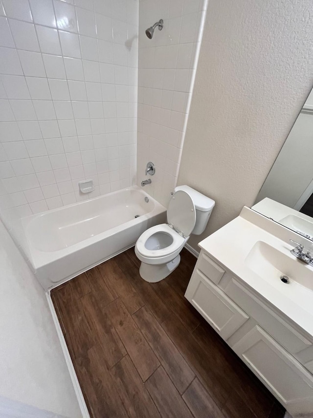 12209 Renewal Way, Houston, TX 77047 - full bathroom featuring vanity, toilet, tiled shower / bath combo, and hardwood / wood-style floors