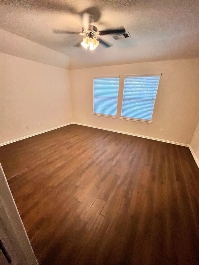 12209 Renewal Way, Houston, TX 77047 - spare room with dark wood-type flooring, ceiling fan, and a textured ceiling