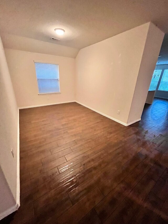 12209 Renewal Way, Houston, TX 77047 - empty room with dark wood-type flooring and lofted ceiling
