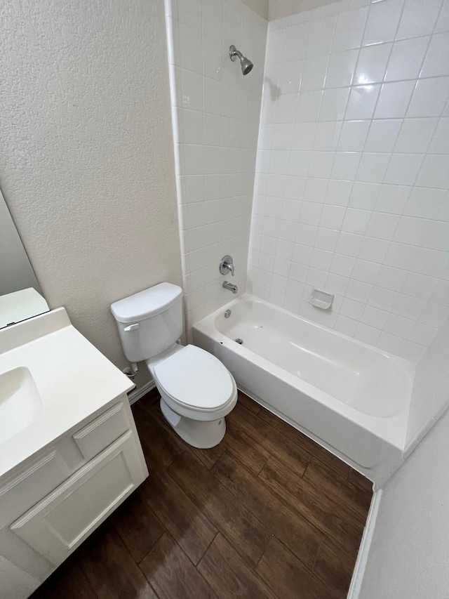 12209 Renewal Way, Houston, TX 77047 - full bathroom with vanity, tiled shower / bath, hardwood / wood-style flooring, and toilet