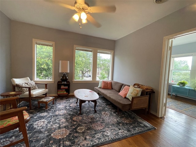 living room with wood-type flooring, plenty of natural light, and ceiling fan