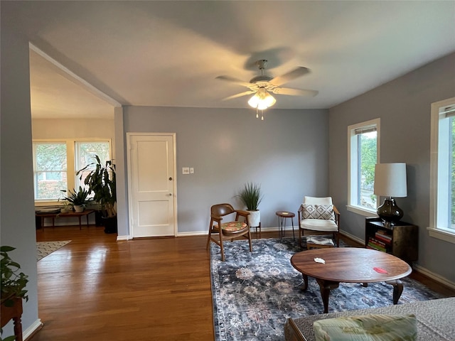 sitting room with ceiling fan, a healthy amount of sunlight, and dark hardwood / wood-style flooring