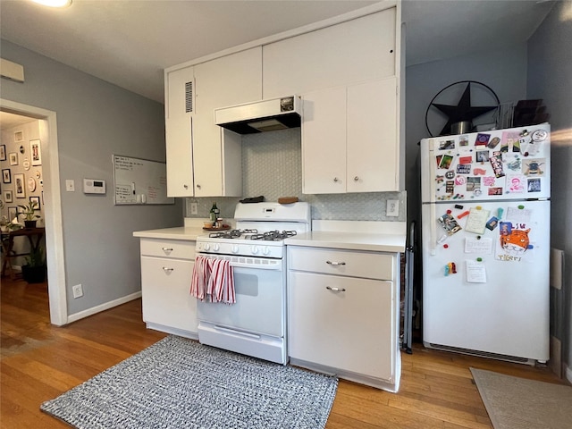 kitchen featuring white appliances, light hardwood / wood-style flooring, white cabinetry, and tasteful backsplash