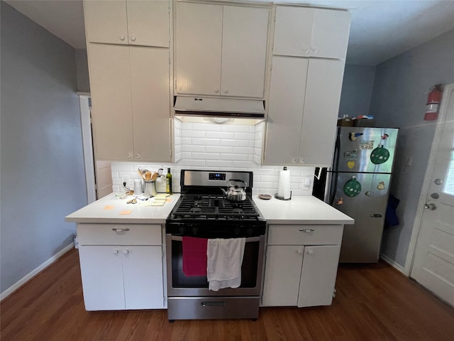 kitchen with dark hardwood / wood-style floors, decorative backsplash, white cabinetry, and appliances with stainless steel finishes