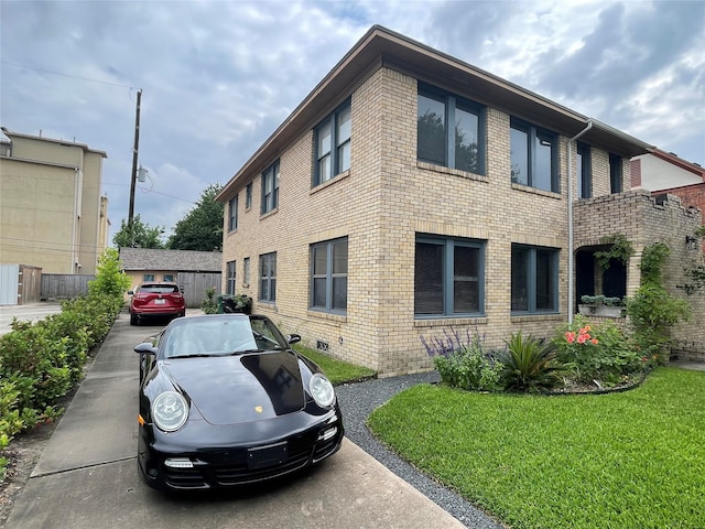 view of side of home with a lawn