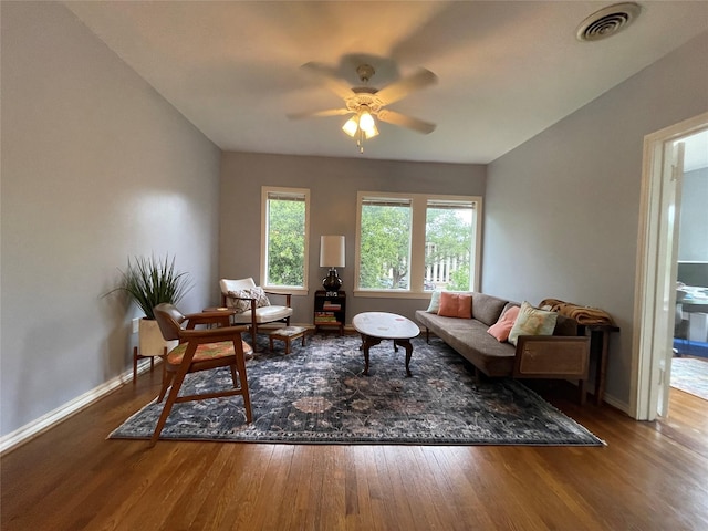 living room featuring wood-type flooring and ceiling fan