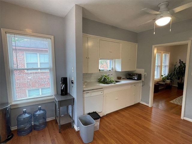 kitchen featuring tasteful backsplash, ceiling fan, sink, dishwasher, and light hardwood / wood-style floors