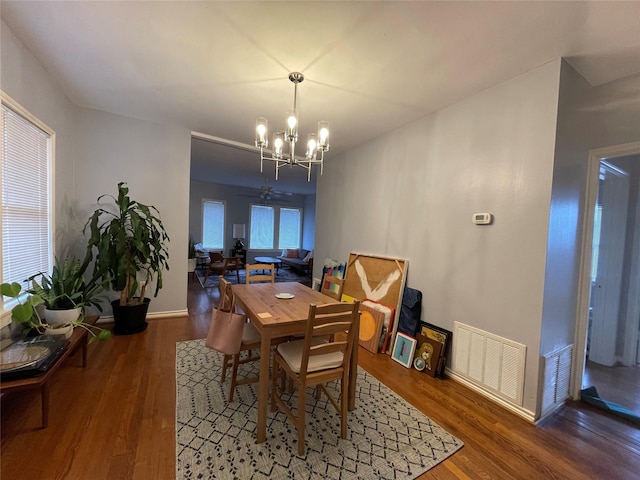 dining room featuring a chandelier and dark hardwood / wood-style flooring