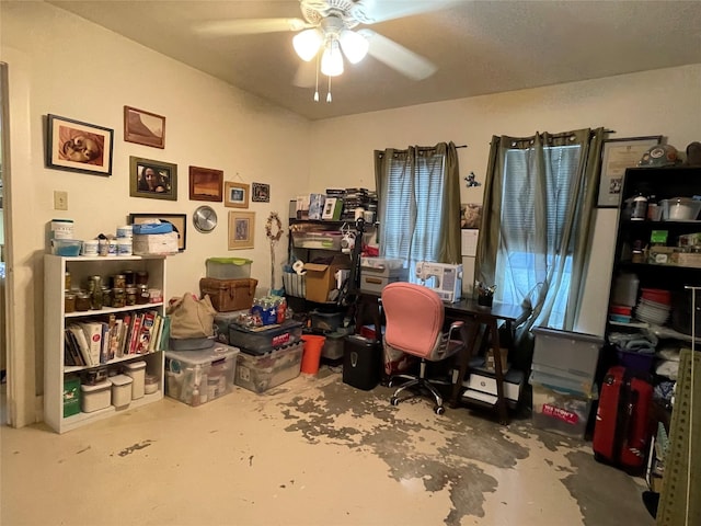 home office featuring ceiling fan and concrete flooring