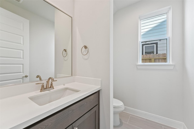 bathroom featuring tile patterned floors, vanity, and toilet