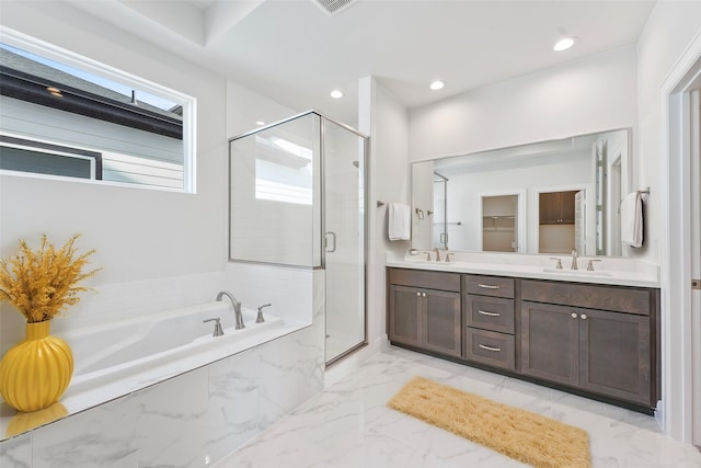 bathroom with vanity and shower with separate bathtub