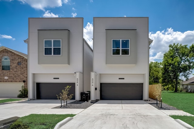 view of front of house featuring a garage and a front lawn