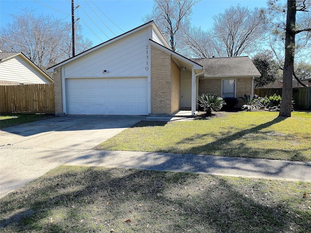 single story home featuring a garage and a front lawn