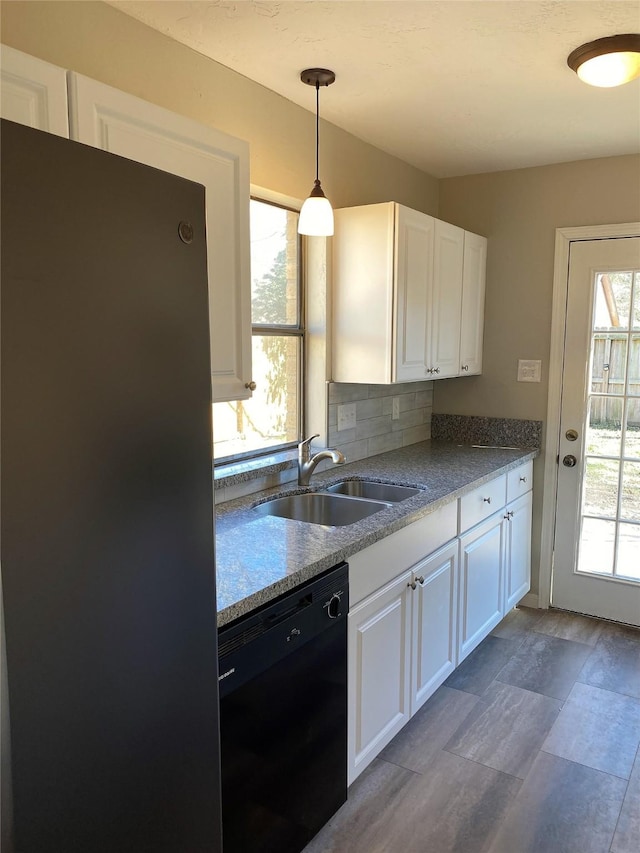 kitchen with stainless steel refrigerator, dishwasher, sink, and white cabinets