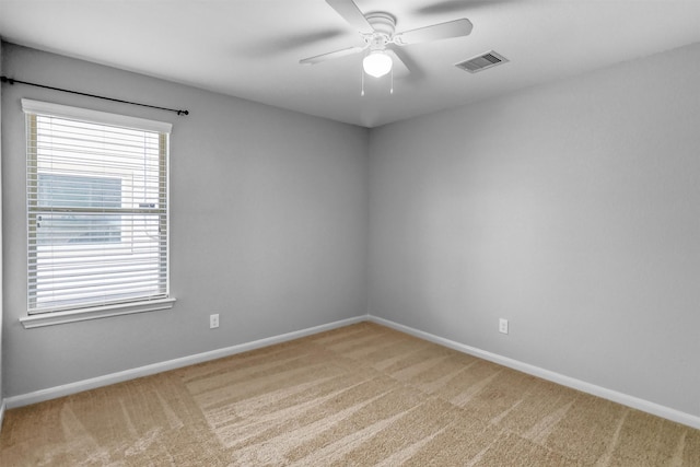 spare room featuring carpet and ceiling fan