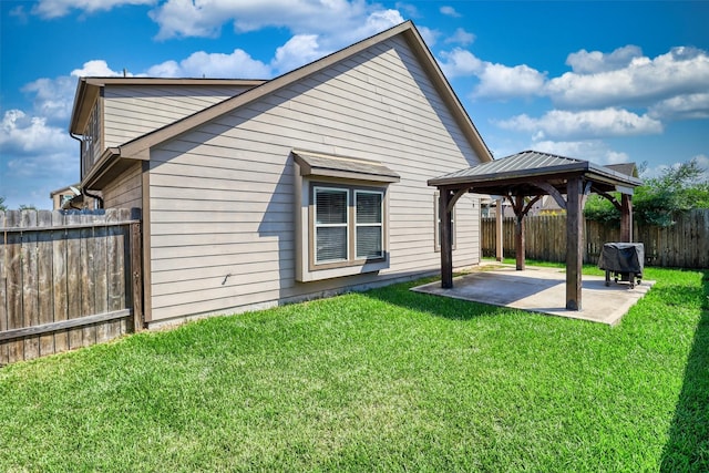 back of house with a gazebo, a patio area, and a lawn