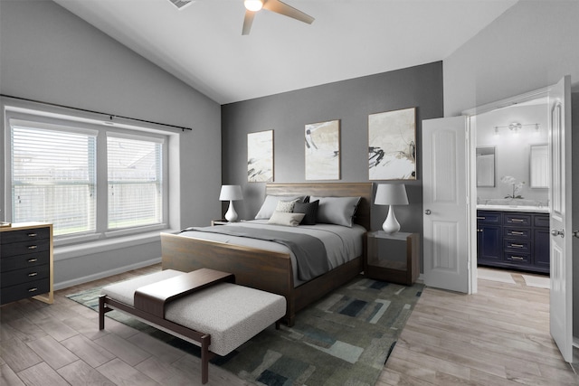 bedroom with ensuite bathroom, vaulted ceiling, and ceiling fan