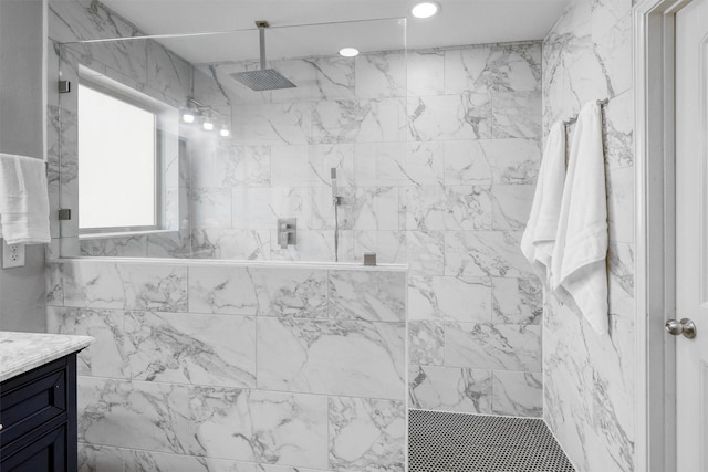 bathroom with vanity and tiled shower