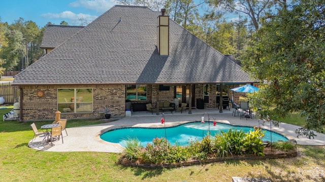 view of swimming pool with a patio area and a lawn