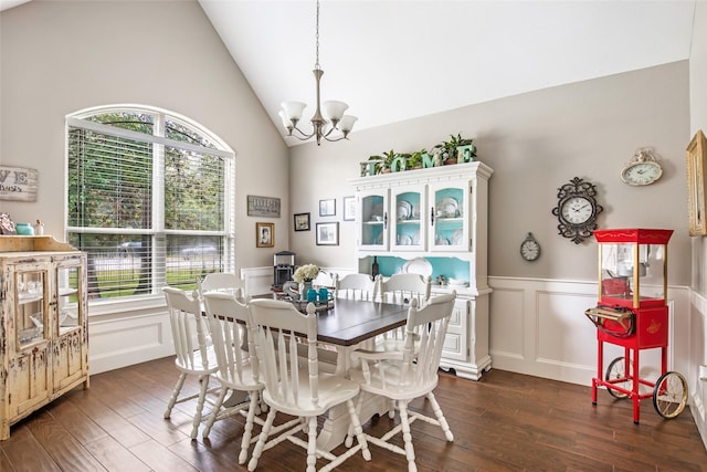 dining area featuring a healthy amount of sunlight, dark hardwood / wood-style flooring, lofted ceiling, and a chandelier