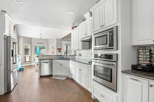 kitchen featuring white cabinets, kitchen peninsula, and stainless steel appliances