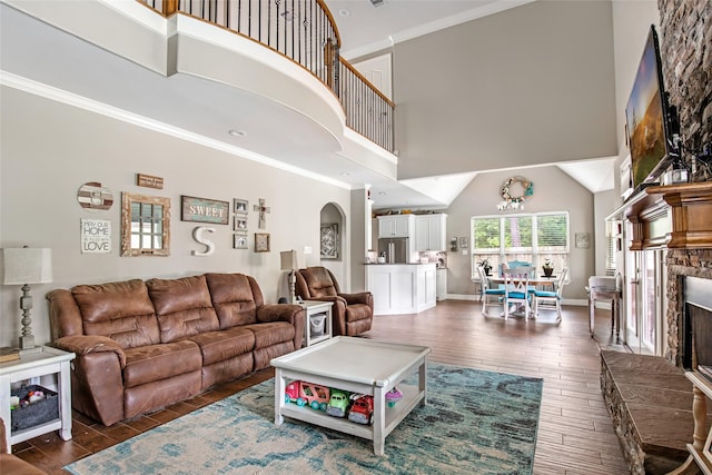 living room featuring a towering ceiling and ornamental molding