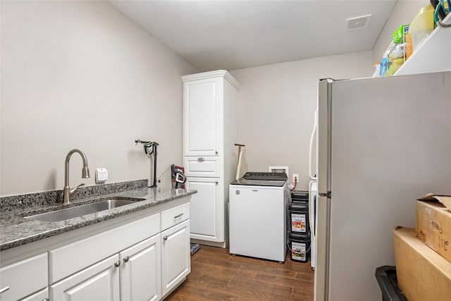 clothes washing area featuring dark hardwood / wood-style floors, sink, and hookup for a washing machine