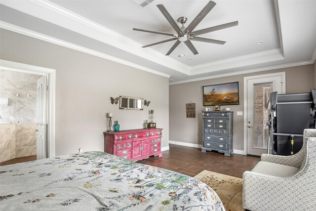 bedroom with ceiling fan, crown molding, connected bathroom, and a tray ceiling