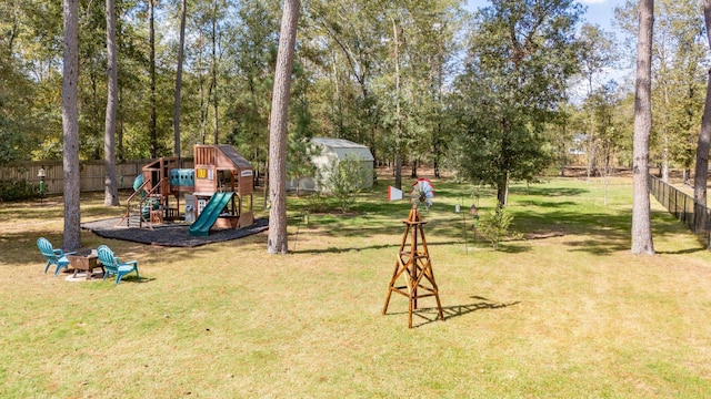 view of playground with a lawn