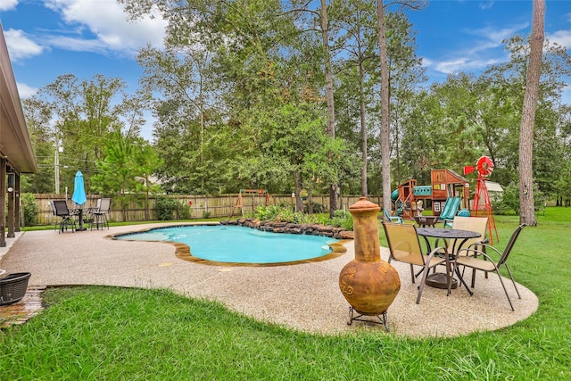 view of swimming pool with a playground, a patio area, and a yard