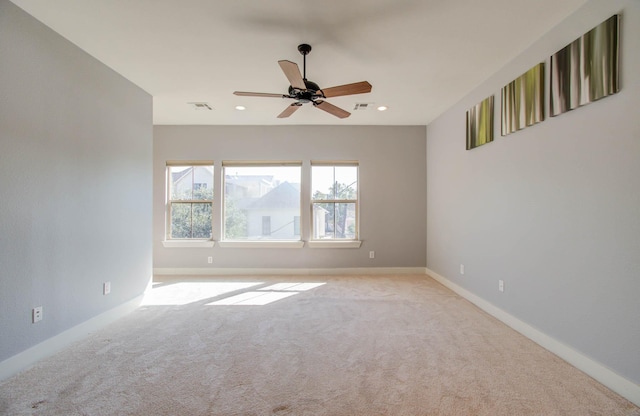 unfurnished room with ceiling fan and light colored carpet